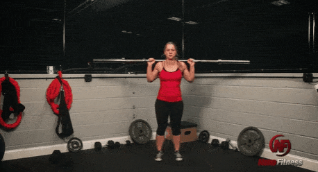 A gif of Coach Staci performing a lunge with a barbell.